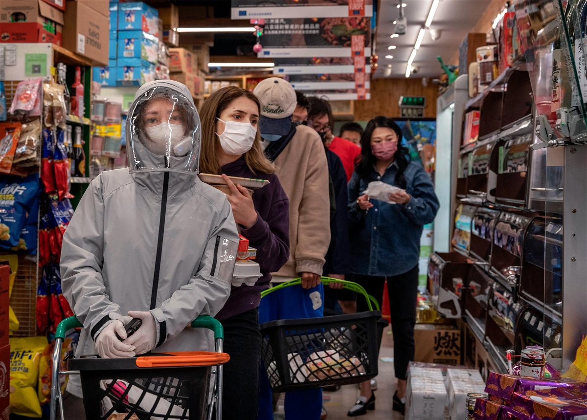 <i>Kevin Frayer/Getty Images</i><br/>People wait in long lines at a supermarket on May 12 in Beijing