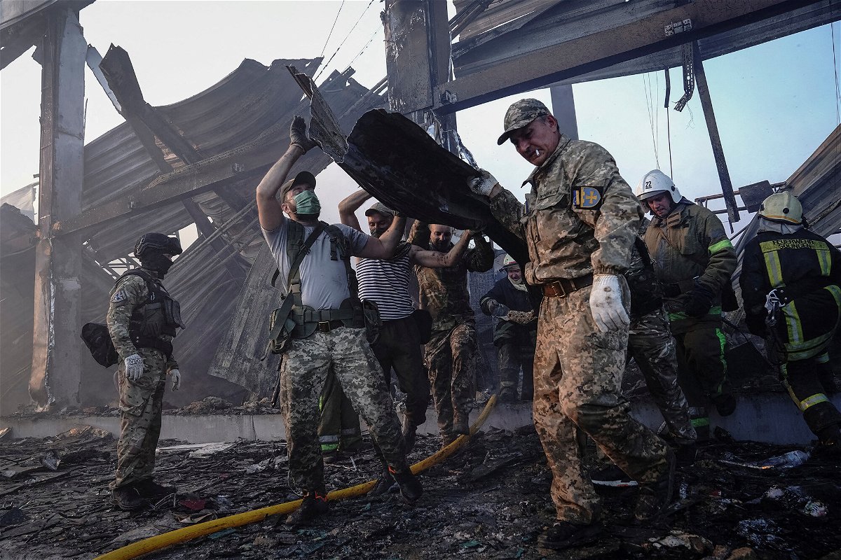 <i>Anna Voitenko/Reuters</i><br/>Rescuers work at a site of a shopping mall hit by a Russian missile strike