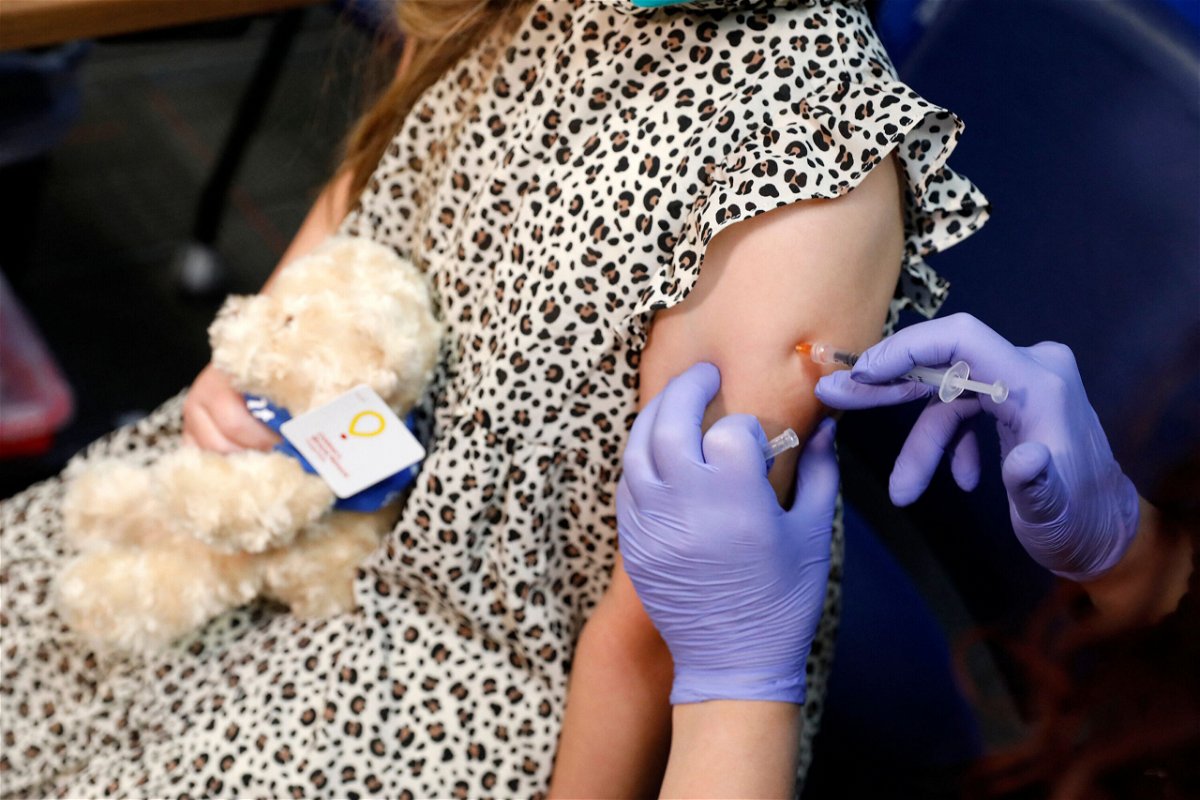 <i>Jeff Kowalsky/AFP/Getty Images</i><br/>A 6 year-old child receives their first dose of  the Pfizer Covid-19 vaccine at the Beaumont Health offices in Southfield