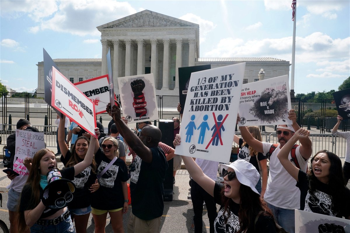 <i>Steve Helber/AP</i><br/>People protest outside the Supreme Court in Washington on Friday