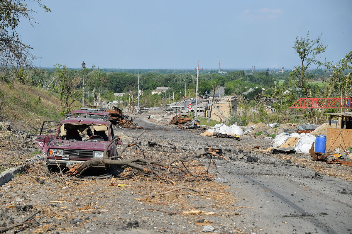 <i>Madeleine Kelly/SOPA Images/LightRocket/Getty Images</i><br/>Debris and destroyed cars are seen along the street in Lysychansk