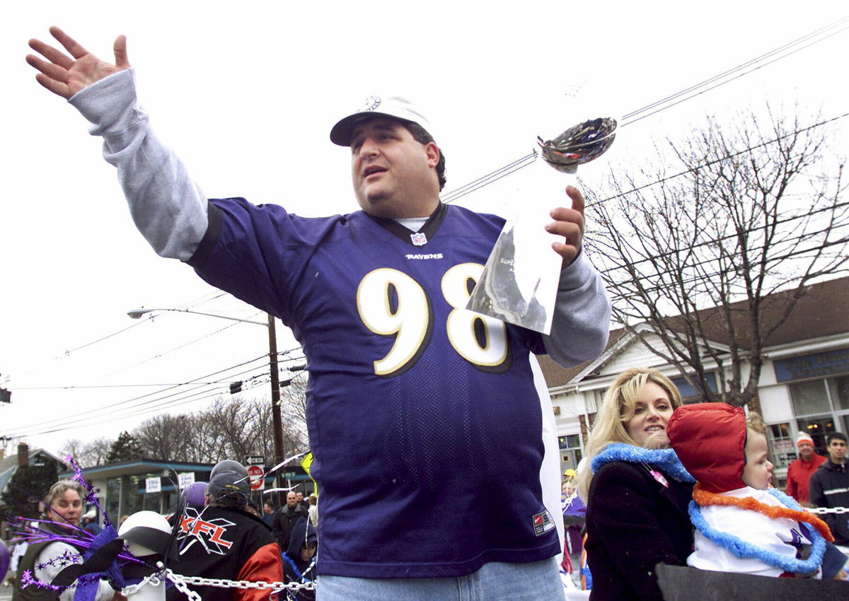 <i>Jeff Zelevansky/AP</i><br/>Tony Siragusa holds the trophy given to the Super Bowl winner during a parade in his hometown of Kenilworth
