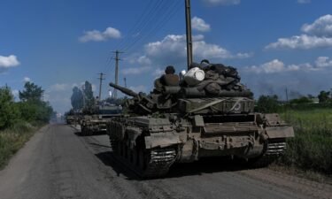 A column of Ukrainian army tanks rolls down a road near Lysychansk on June 19.