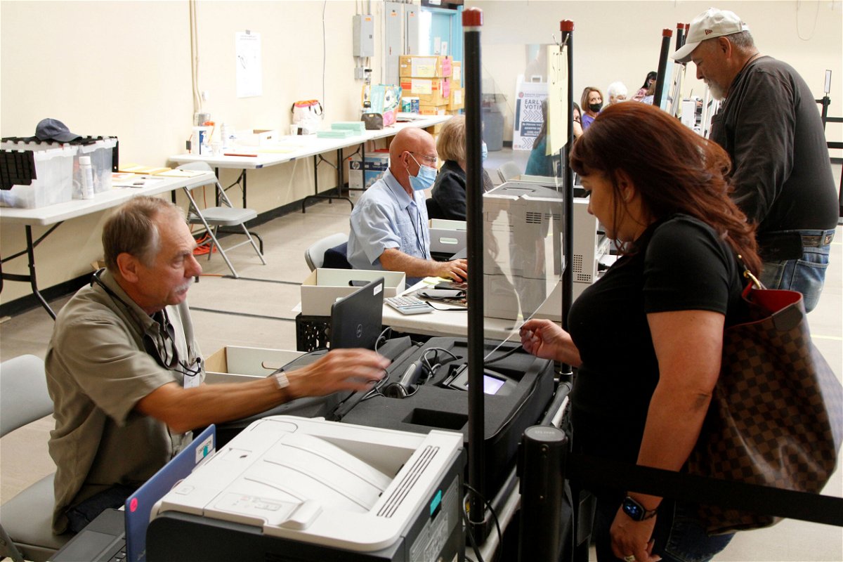 <i>Morgan Lee/AP</i><br/>A woman signs in to receive a primary election ballot at an early voting center in Santa Fe