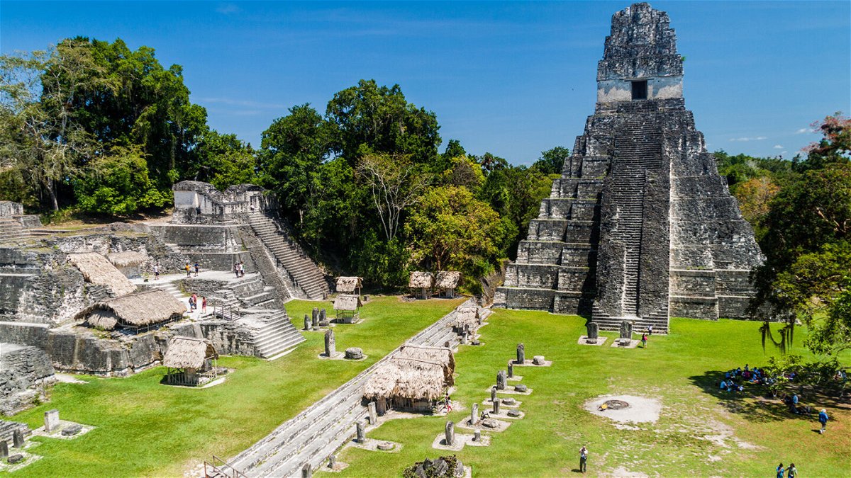 <i>Matyas Rehak/Adobe Stock</i><br/>Tourists gather at the archaeological site Tikal