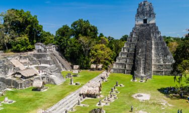 Tourists gather at the archaeological site Tikal