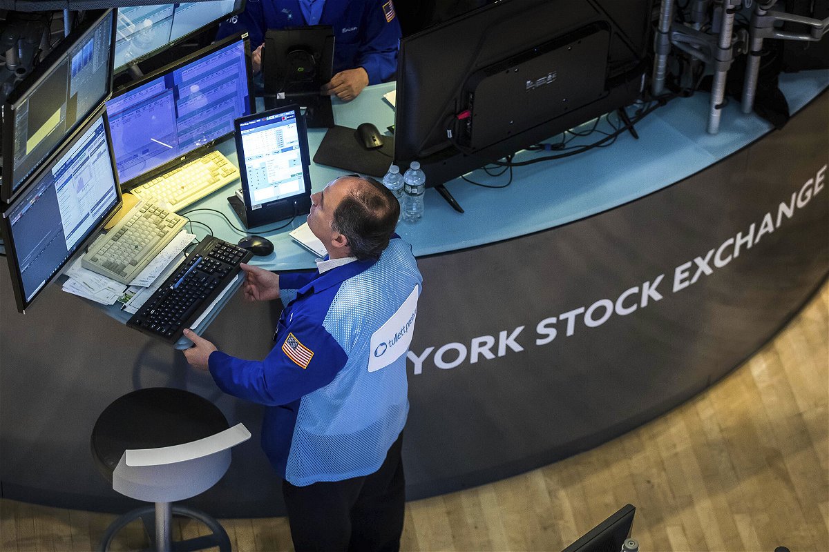 <i>Courtney Crow/New York Stock Exchange/AP</i><br/>A trader works at his post on the New York Stock Exchange floor