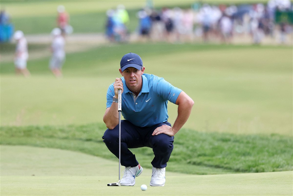 <i>Rob Carr/Getty Images</i><br/>McIlroy lines up his putt on the second green.