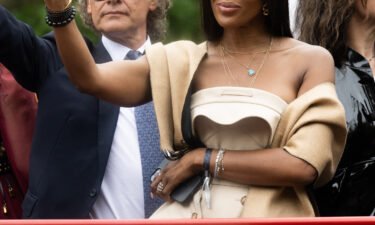 Supermodel Naomi Campbell waved to her adoring public atop one of the pageant parade floats