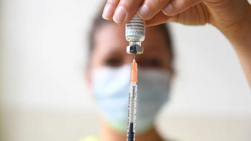 A woman holds a syringe with a dose of the monkeypox vaccine at a vaccination center in Paris this week. Health experts say Texas colleges should begin providing information about the virus — and planning for potential outbreaks.