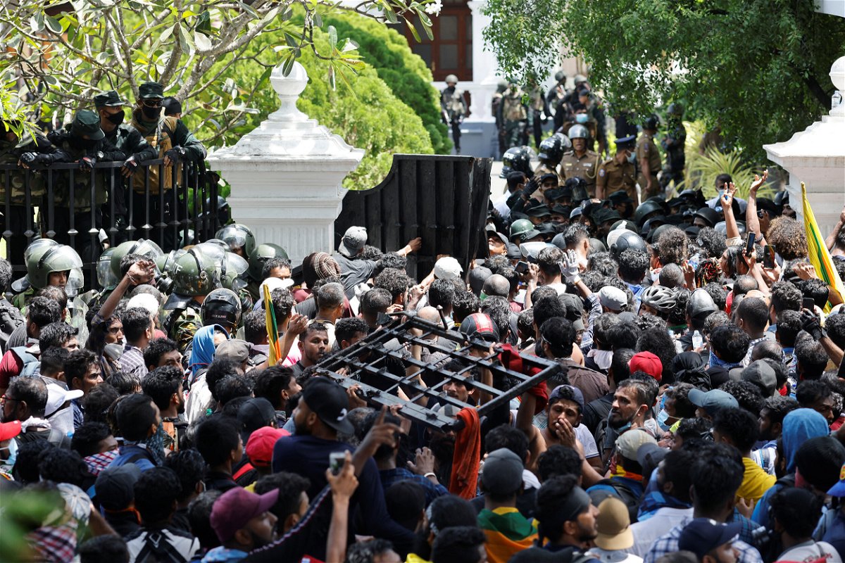 <i>Adnan Abidi/Reuters</i><br/>Demonstrators carry the gate to Sri Lanka's Prime Minister Ranil Wickremesinghe's office premises