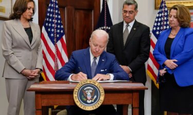 President Joe Biden signs an executive order on abortion access during an event in the Roosevelt Room of the White House