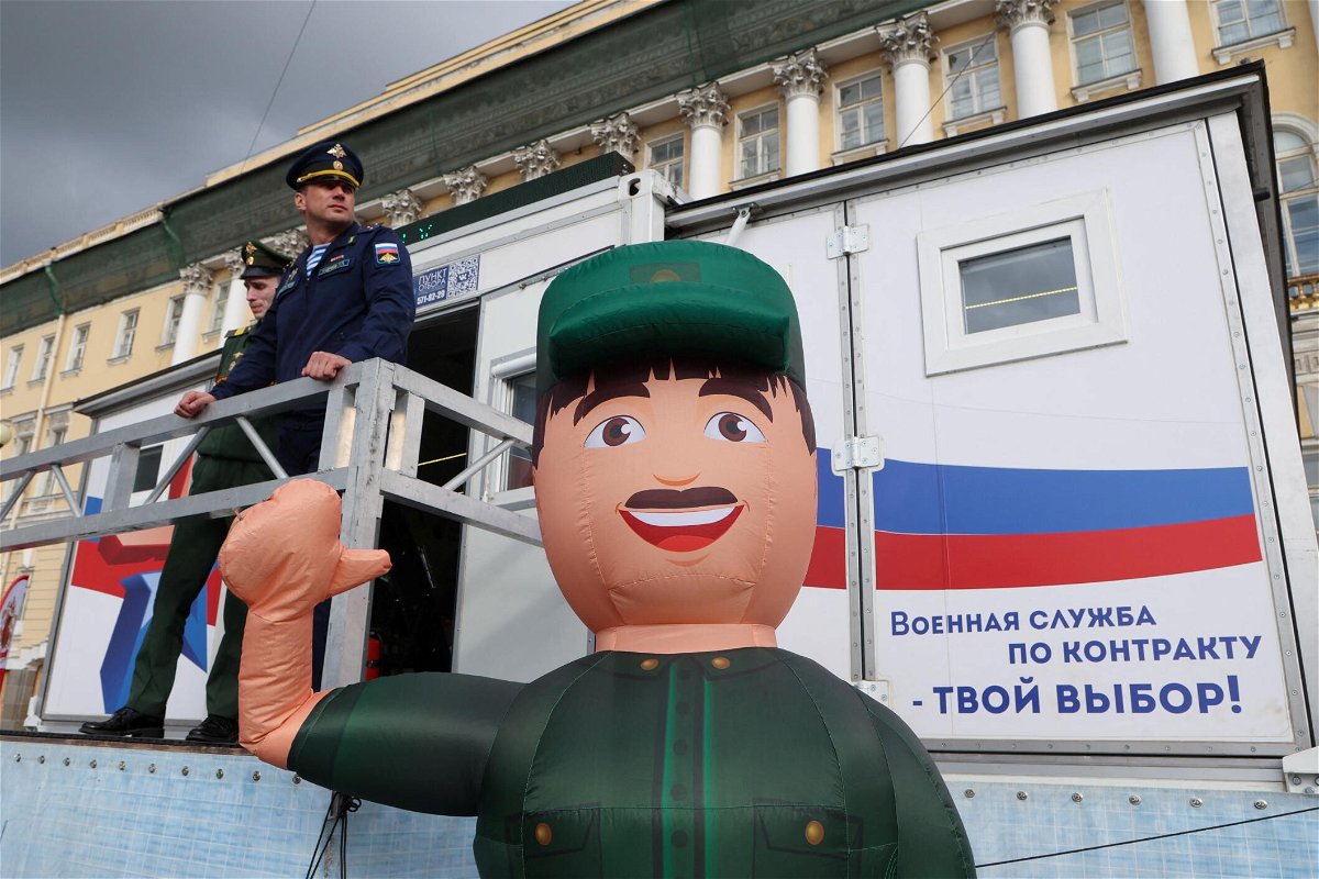 <i>Anton Vaganov/Reuters</i><br/>Russian Army servicemen stand outside a mobile recruiting center in central Saint Petersburg on May 28.