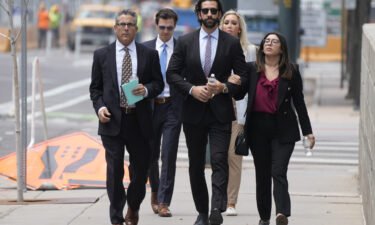 Pittsburgh dentist Lawrence Rudolph's defense investigator heads into federal court in Denver with the dentist's children.