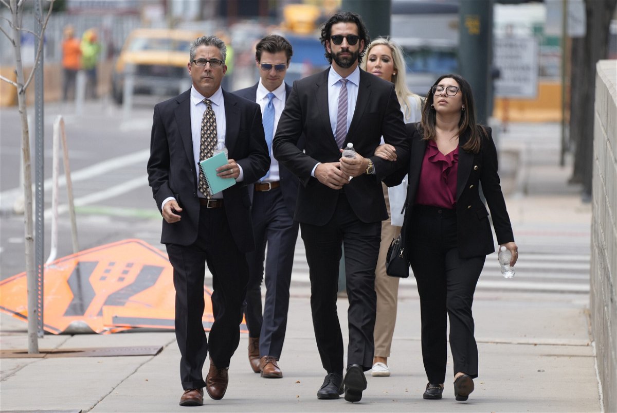 <i>David Zalubowski/AP</i><br/>Pittsburgh dentist Lawrence Rudolph's defense investigator heads into federal court in Denver with the dentist's children.