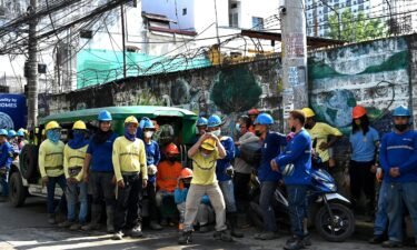 Construction workers evacuate a building after a 7.1-magnitude earthquake