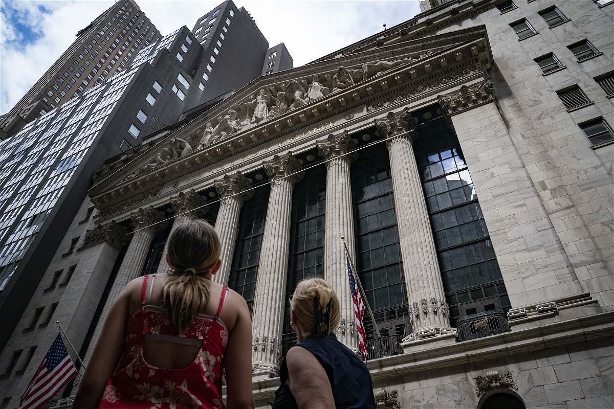 <i>John Minchillo/AP</i><br/>Pedestrians walk past the New York Stock Exchange Thursday