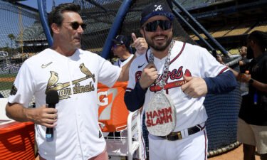 Jon Hamm talks with Travis d'Arnaud of the Atlanta Braves during the 2022 Gatorade All-Star Workout Day at Dodger Stadium on July 18 in Los Angeles.