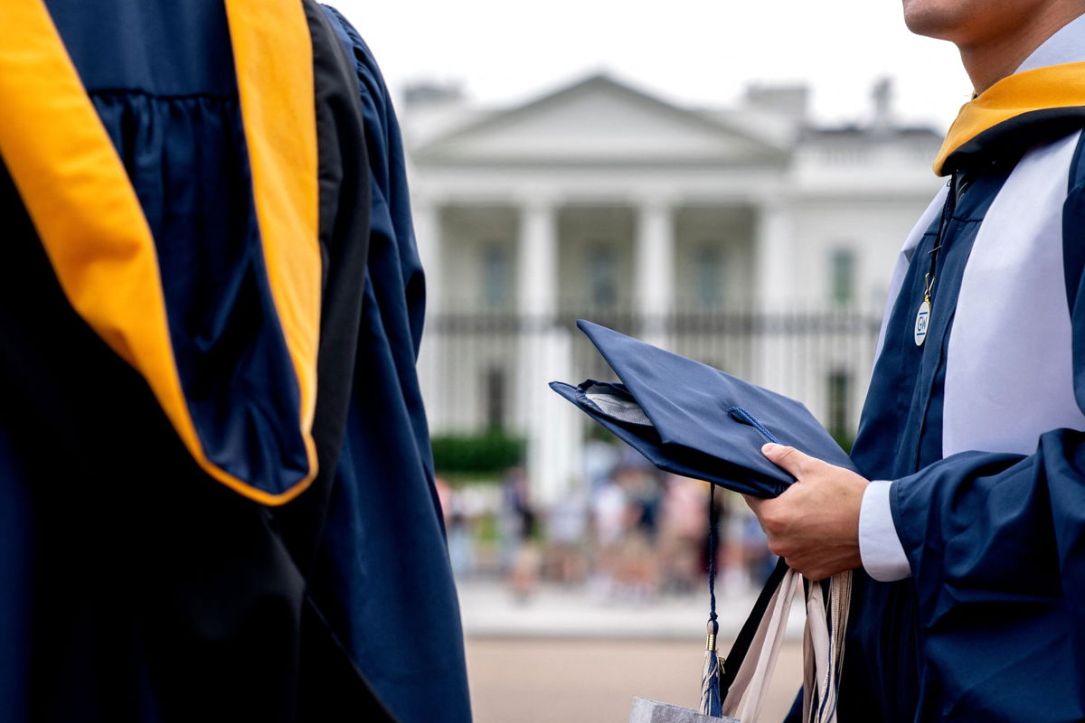 <i>Stefani Reynolds/AFP/Getty Images</i><br/>Students from George Washington University wear their graduation gowns outside of the White House in Washington