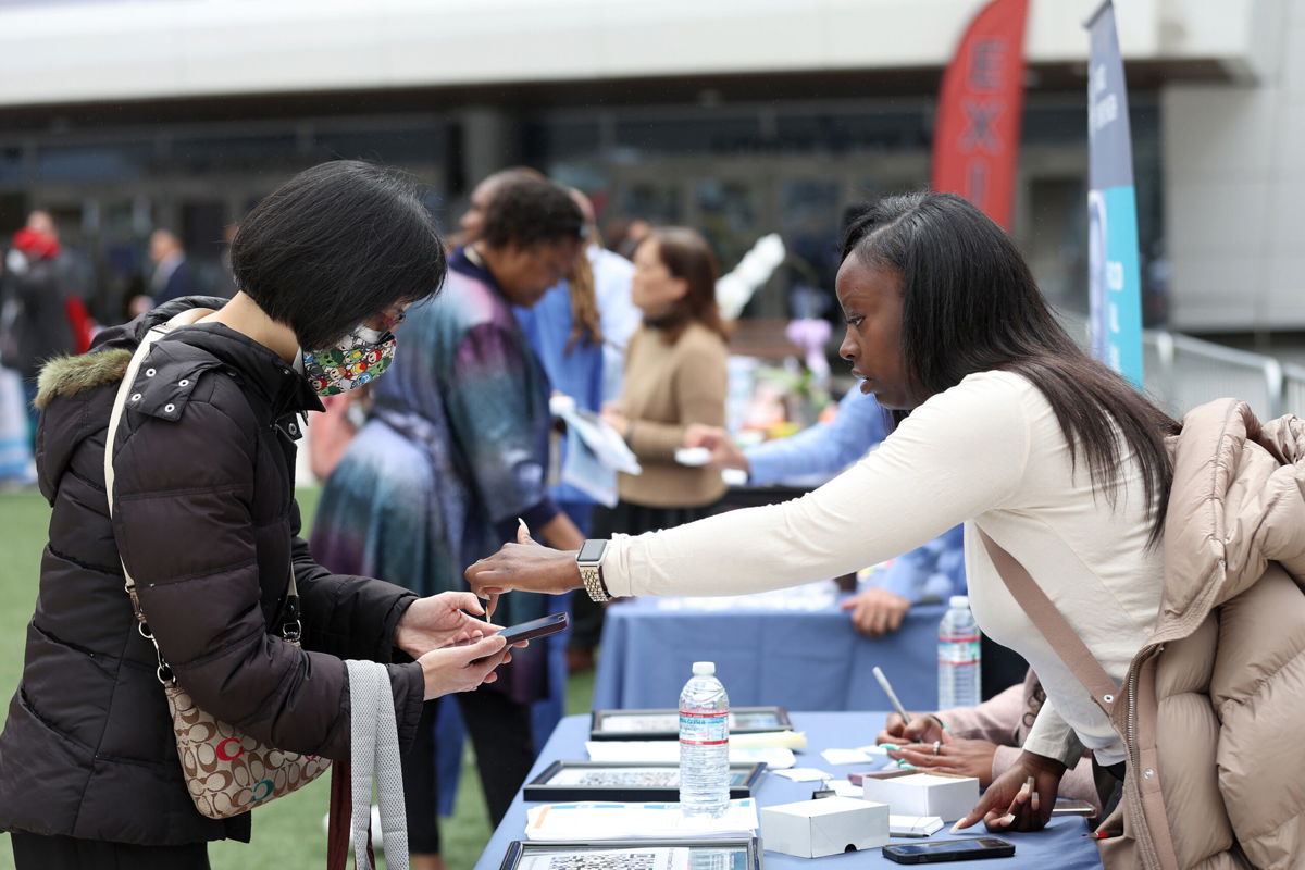<i>Justin Sullivan/Getty Images</i><br/>A job seeker meets with a recruiter during the Healthcare Academy career and training fair outside of the Chase Center on June 03