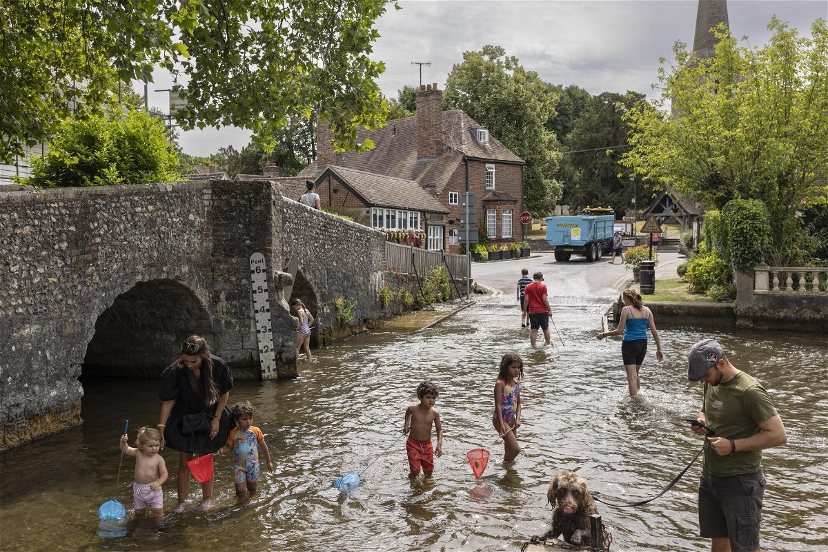 <i>Dan Kitwood/Getty Images Europe/Getty Images</i><br/>Families cool off in the River Darent on July 12 in Eynsford