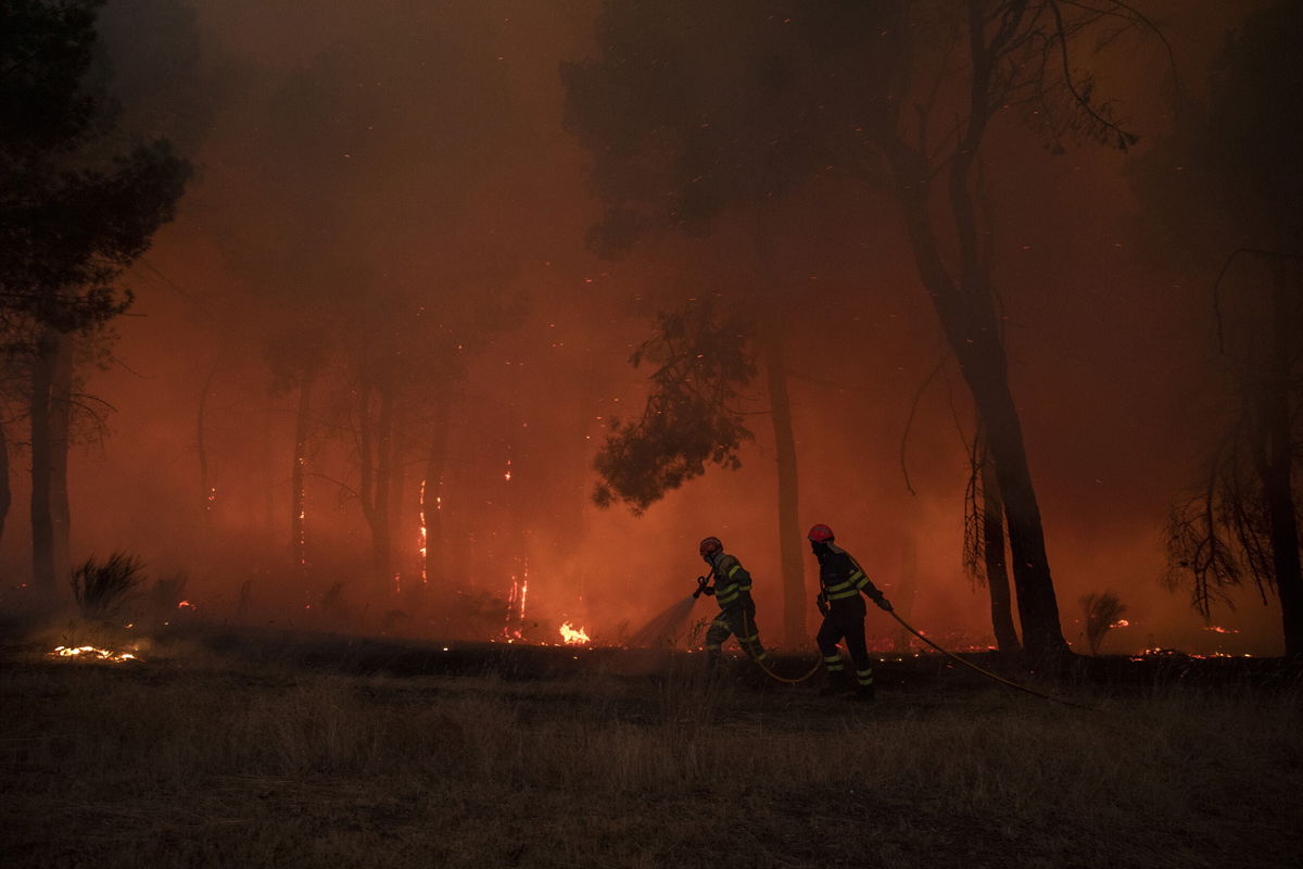 <i>Pablo Blazquez Dominguez/Getty Images</i><br/>Firefighters tackle a forest fire approaching houses on July 18
