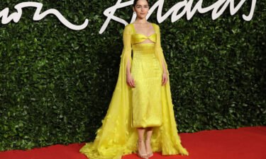 Emilia Clarke poses on the red carpet upon arrival at The Fashion Awards 2019 in London on December 2