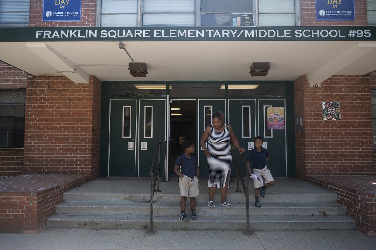 <i>Vincent Alban/The Baltimore Sun/AP/File</i><br/>A Baltimore parent picks up her children at Franklin Square Elementary/Middle School in May