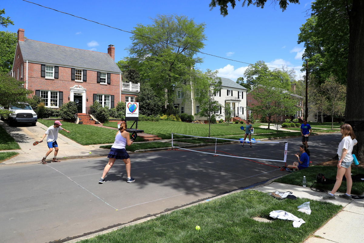 <i>Streeter Lecka/Getty Images North America/Getty Images</i><br/>People play pickleball on an empty street in Charlotte during the early days of the coronavirus pandemic.