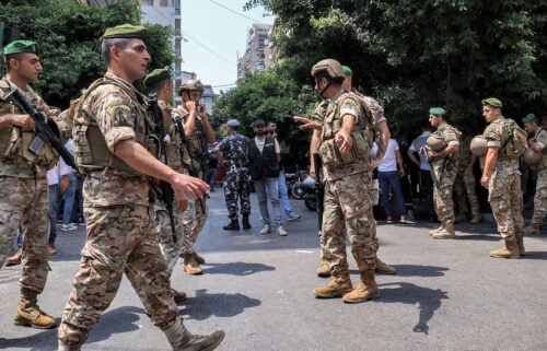 Army soldiers gather near a bank in Beirut
