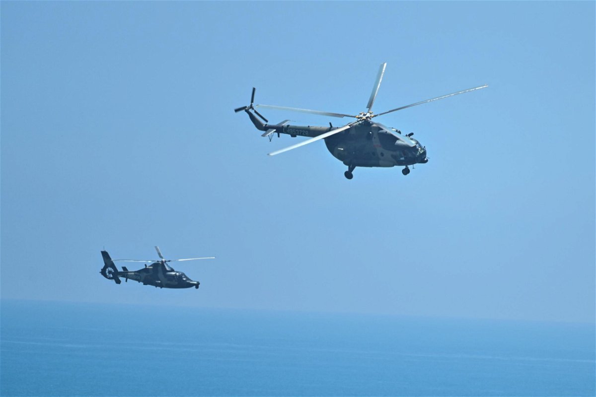 <i>Hector Retamal/AFP/Getty Images</i><br/>Chinese military helicopters fly past Pingtan island