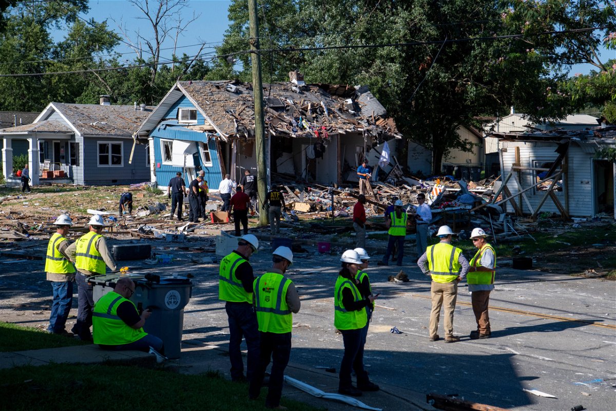 <i>MaCabe Brown/Evansville Courier & Press/AP</i><br/>Emergency personnel search the debris left behind by an August 11