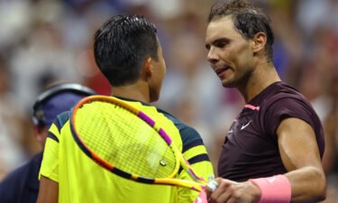 Rafael Nadal (right) and Rinky Hijikata meet at the net following their first-round match.