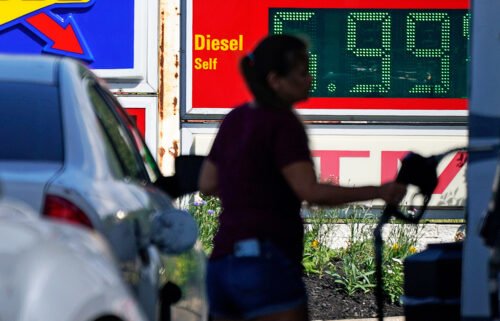 Prices in the US stayed the same last month. A woman pumps gas at a Sunoco mini-mart in Independence