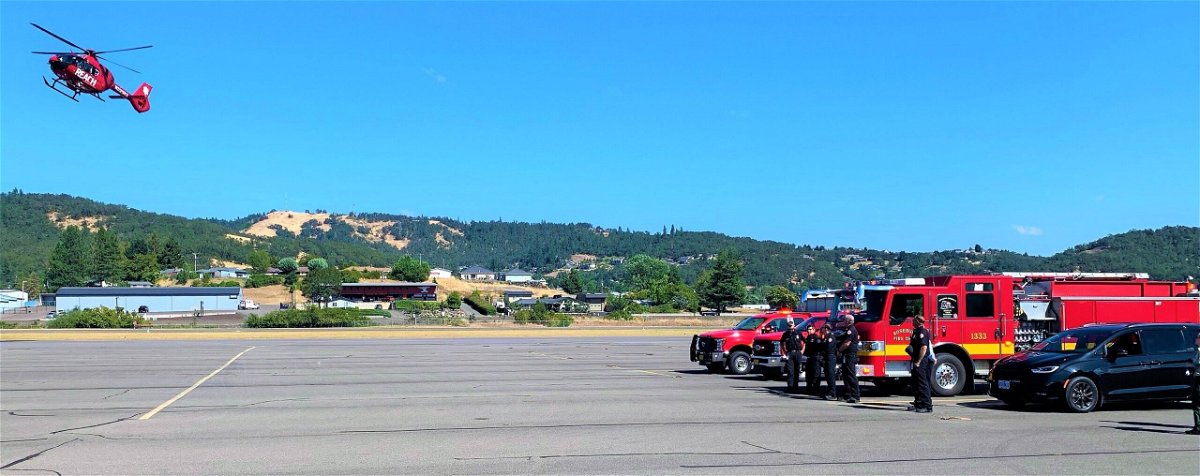 <i>Douglas County Sheriff's Office</i><br/>A medical helicopter carrying the firefighter's body arrives at the Roseburg Regional Airport in Oregon.
