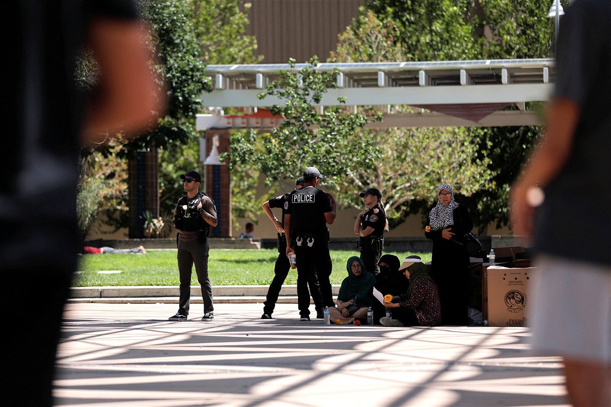 <i>Adria Malcolm/REUTERS</i><br/>Members of the Albuquerque Police Department standby during a unity event following the murders of four Muslim men in Albuquerque