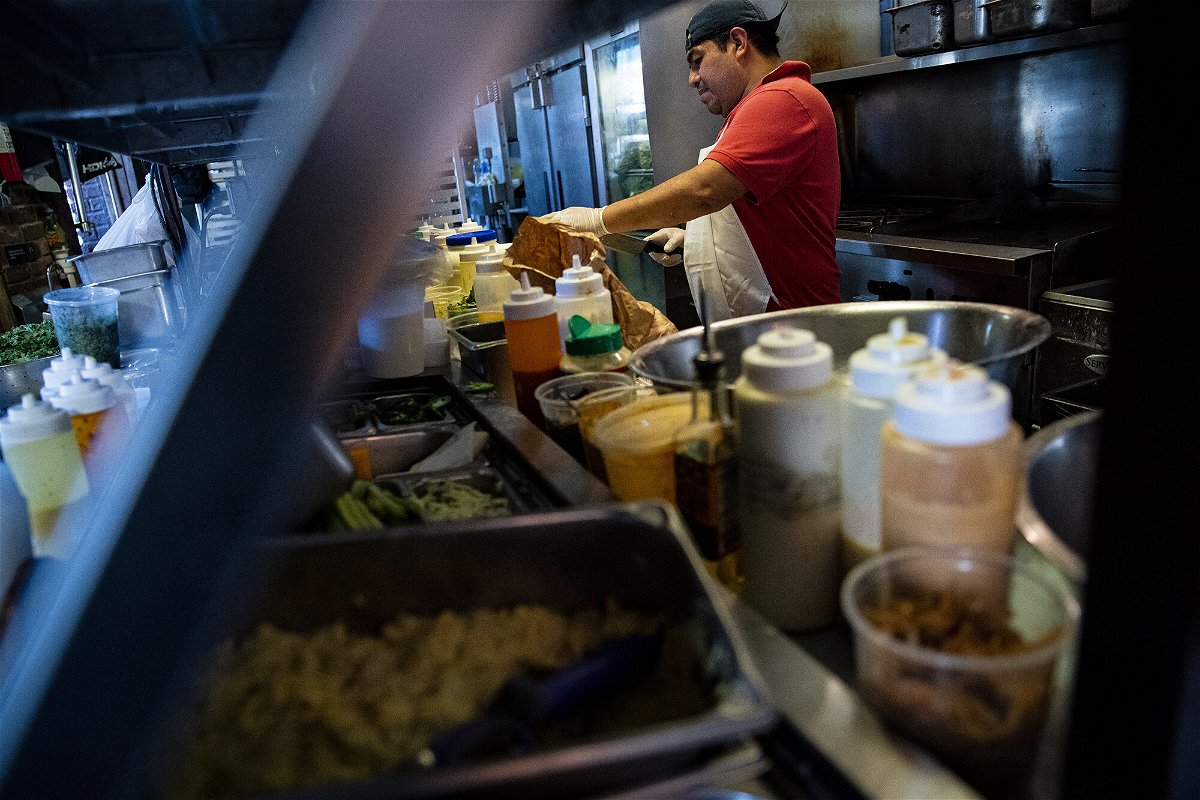 <i>Al Drago/Bloomberg/Getty Images</i><br/>A restaurant worker prepares a sauce at a tavern in Washington