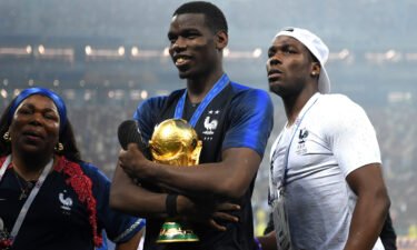 Paul Pogba (c) celebrates victory with mother Yeo and brother Mathias during the 2018 FIFA World Cup final.