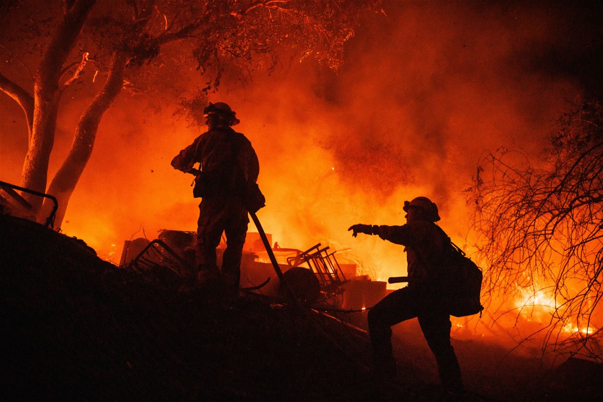 <i>Ethan Swope/AP</i><br/>Firefighters are seen here battling the fast-moving Fairview Fire near Hemet