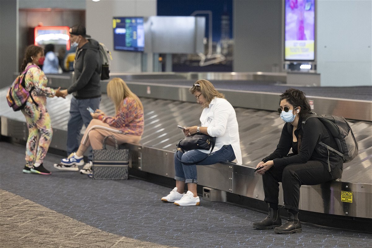 <i>Angus Mordant/Bloomberg/Getty Images</i><br/>Travelers wait at LaGuardia Airport in the Queens borough of New York on July 1.