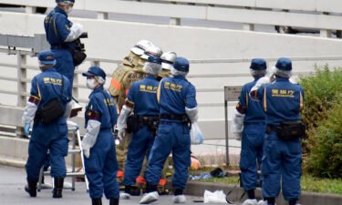 Japanese police and firefighters are pictured here at the scene near the prime minister's office in Tokyo where a man reportedly set himself on fire on September 21.