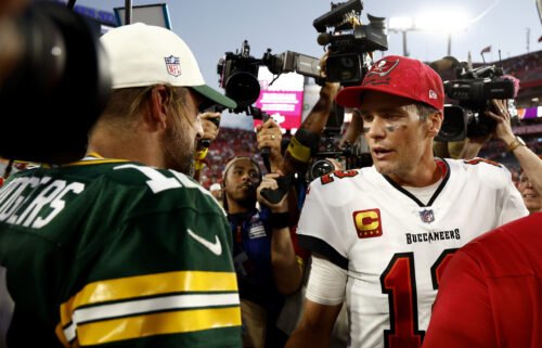 Aaron Rodgers (left) and Tom Brady greet each other after Sunday's game.