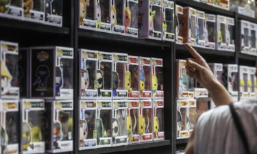 Toy companies expect grown-ups to shop more for other adults this holiday season. A man is seen here pointing to a shelf of 'Funko Pop' items on July 1