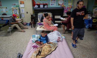 Evacuees are seen in a classroom of a public school being used as a shelter as Hurricane Fiona and its heavy rains approach in Guayanilla