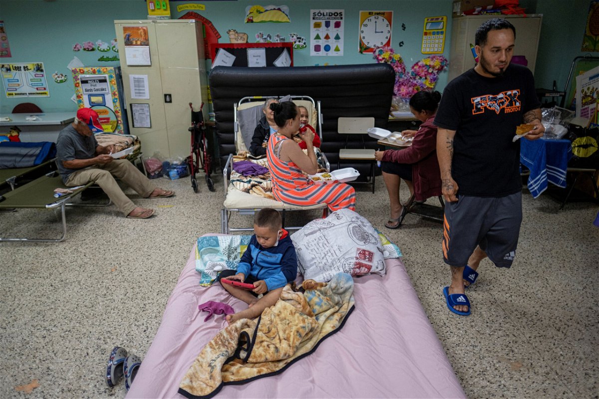 <i>Ricardo Arduengo/Reuters</i><br/>Evacuees are seen in a classroom of a public school being used as a shelter as Hurricane Fiona and its heavy rains approach in Guayanilla