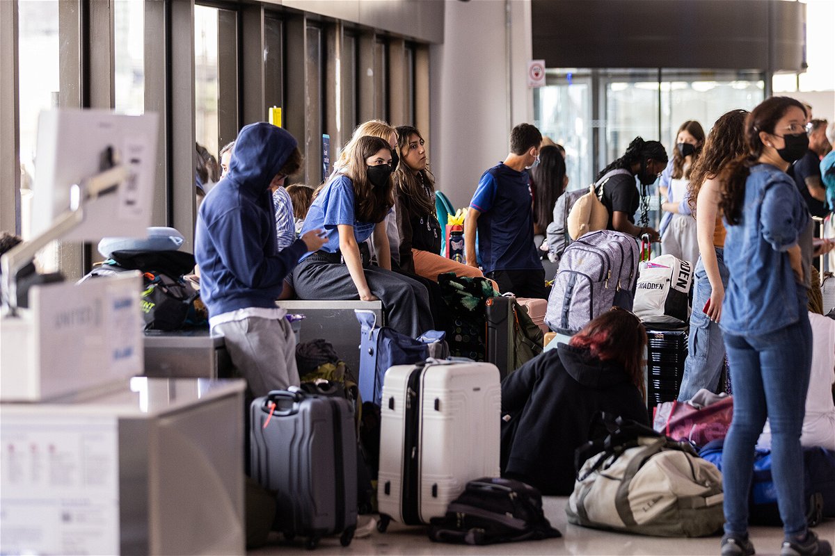 <i>Jeenah Moon/Getty Images</i><br/>Travelers wait at Newark Liberty International Airport on July 1 The airport was plagued with cancellations and delays this summer.