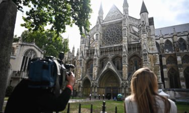 A camera operator films the Westminster Abbey