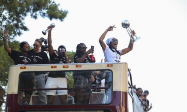 The Las Vegas Aces celebrate their WNBA championship with an open-topped bus parade in front of thousands of fans on the Las Vegas Strip on Tuesday