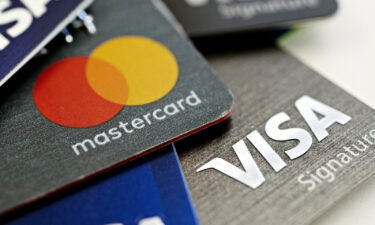 US credit card giants said they will implement a new merchant category code for the nation's gun retailers. Visa and Mastercard credit cards are arranged for a photograph in Tiskilwa