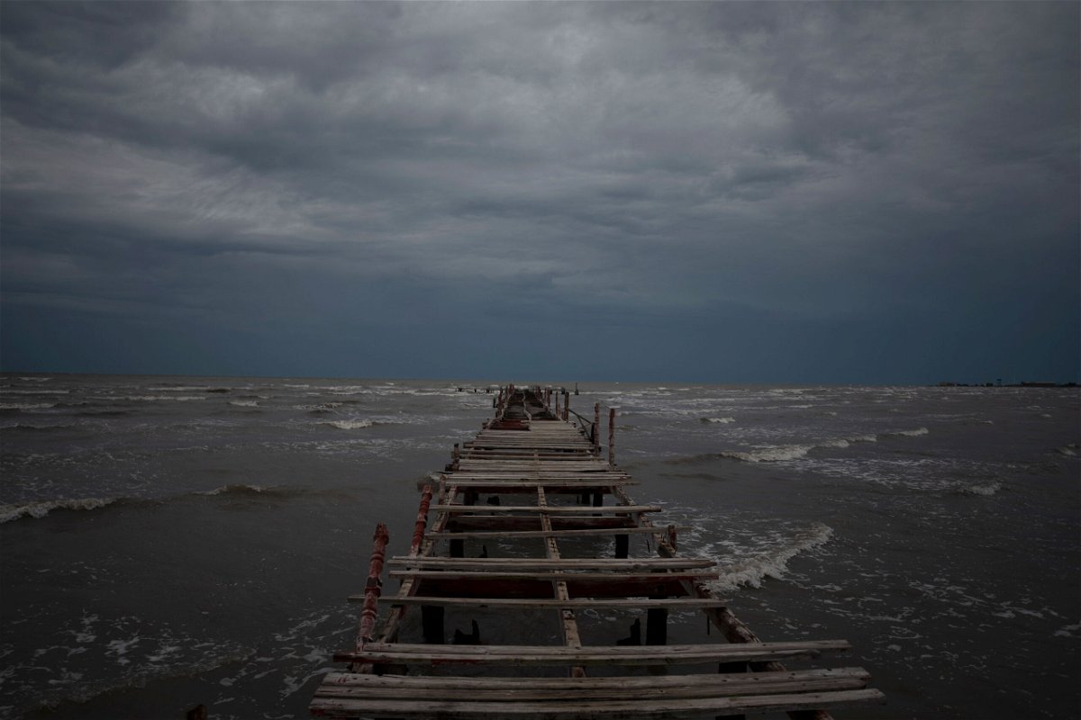 Waves kick up under a dark sky along the shore of Batabano, Cuba, Monday, Sept. 26, 2022. Hurricane Ian was growing stronger as it approached the western tip of Cuba on a track to hit the west coast of Florida as a major hurricane as early as Wednesday. (AP Photo/Ramon Espinosa)